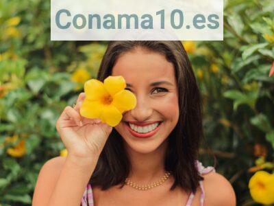woman in white and purple tank top holding yellow flower